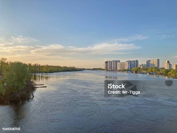 View Of The Deep River With The Buildings In The Background Beautiful Panoramic View Of The City Of Kyiv Dneper River At Sunset On Dark Blue Water With Glowing Reflected Rays Of The Sun Copyspace Stock Photo - Download Image Now