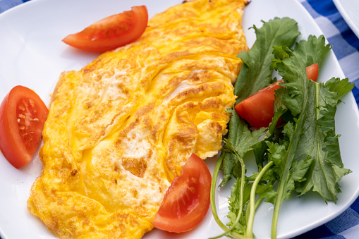 Omelette served with tomatoes and cress on the breakfast table