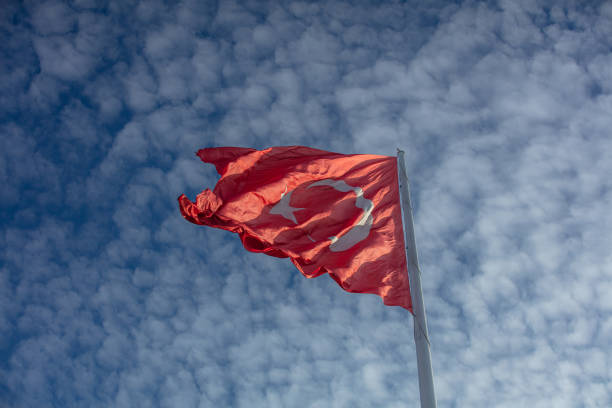 istock Turkish flag with cloudy blue sky as a background 1469255445
