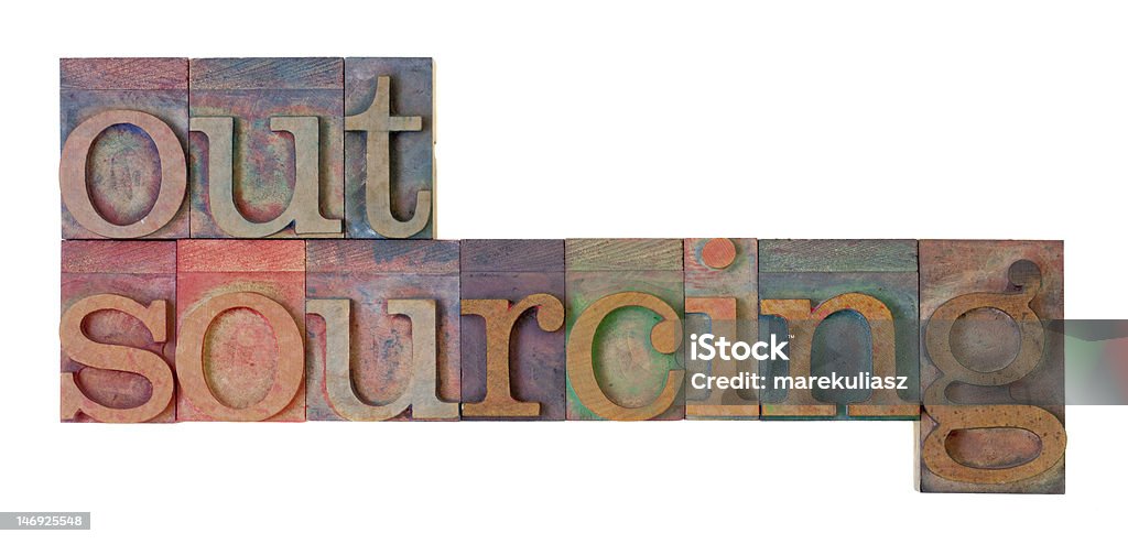 outsourcing outsourcing word in vintage wood letterpress type blocks, stained by color ink, isolated on white Business Stock Photo