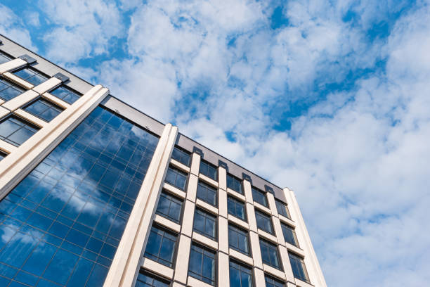 istock Bottom view on building of business-centre on blue sky background. Modern architecture. 1469257932