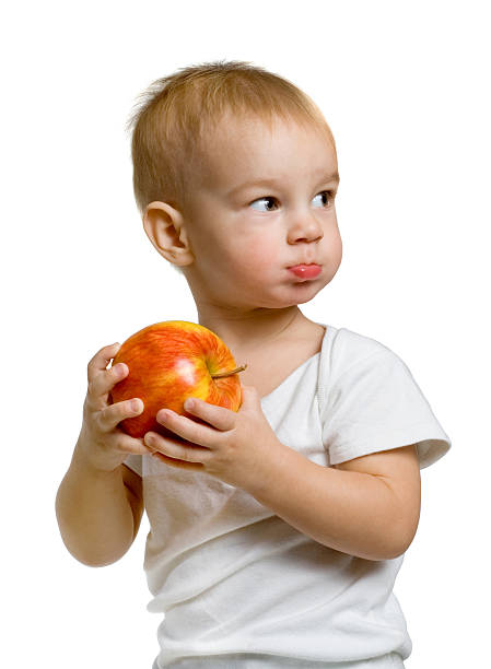 child with an apple stock photo