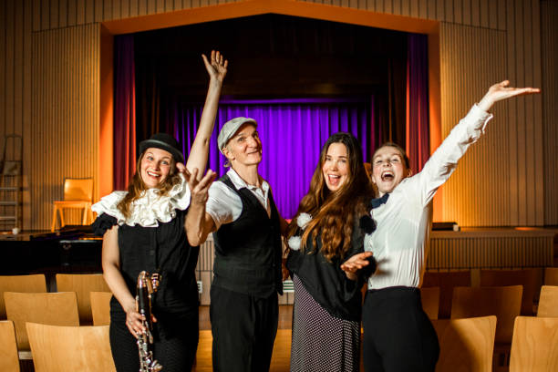 Four actors on stage taking the applause