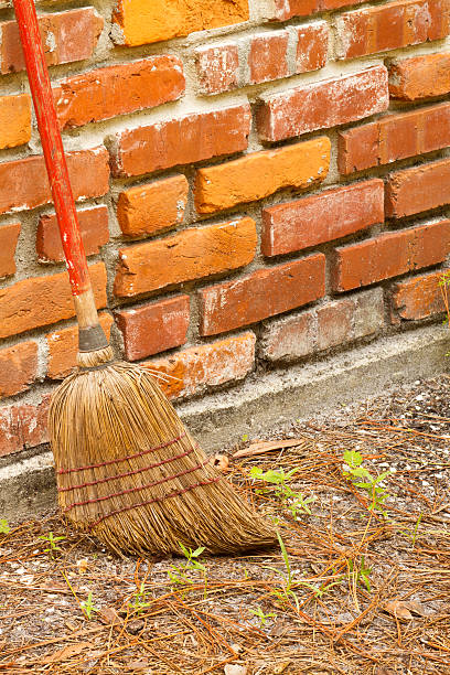 istock Old Broom Leaning Against Brick Chimney 146926065