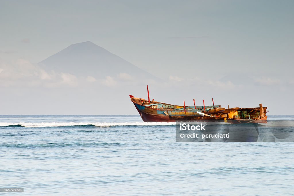 Ship wreck in Gili Trawangan A colored ship wreck in Gili Trawangan, Lombok, Indonesia. On the background, mount Gunung Agung in Bali. Accidents and Disasters Stock Photo