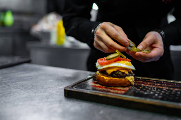 istock chef hand cooking cheeseburger on restaurant kitchen 1469262135