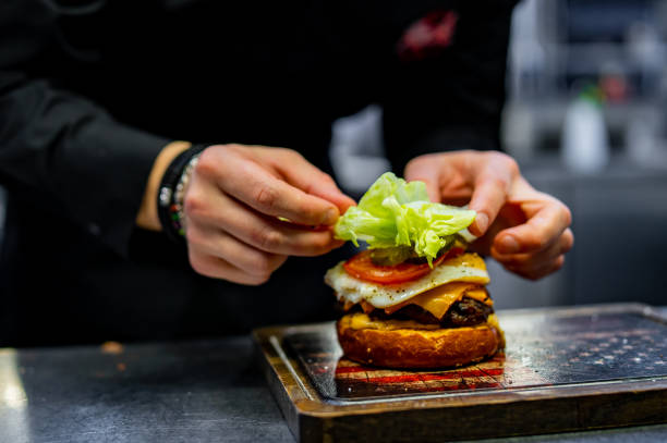 istock chef hand cooking cheeseburger on restaurant kitchen 1469262160