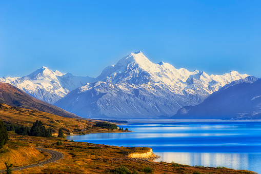 Spectacular Mt Cook snow capped rocky peak over Lake Pukaki of Tasman valley in New Zealand.