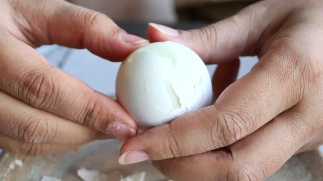 women hand perfectly Peeled Boiled Eggs