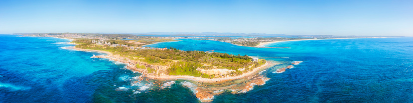 Scenic Swansea heads at Caves beach entrance to Lake Macquarie pacific ocean in wide aerial seascape panorama.