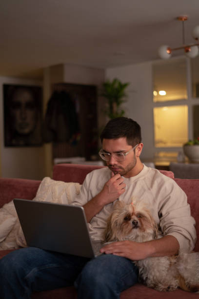 istock Man using his laptop to surf the internet at home 1469265290