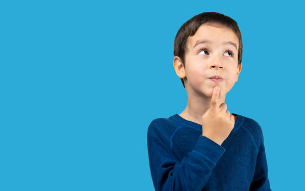 istock Pensive kid looks away at copy space thinking 1469265306