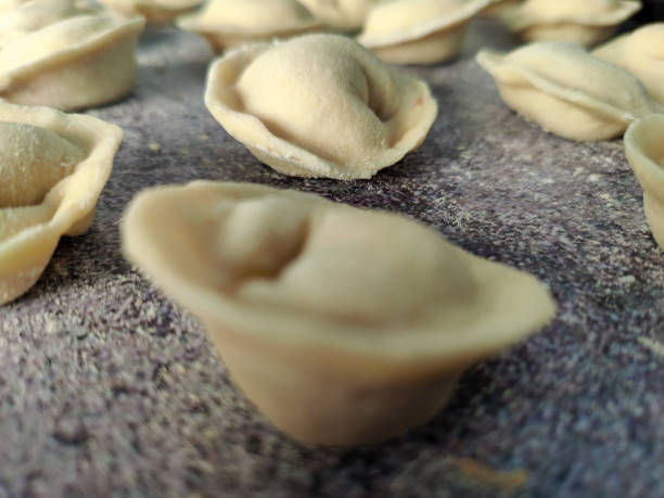 istock Pelmeni. Raw semi-finished dumplings on a black plate 1469265594