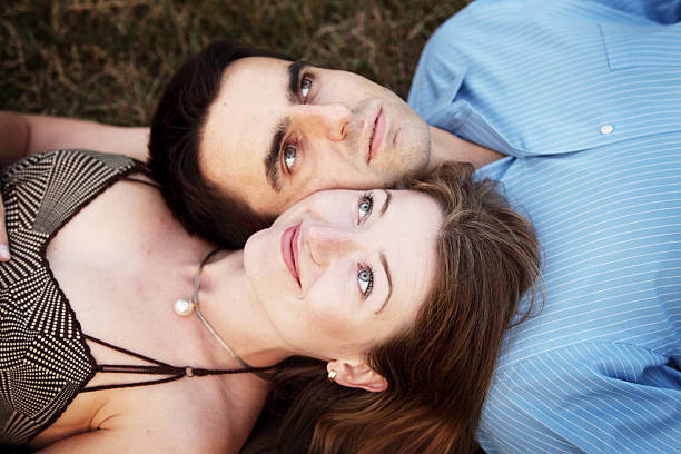 Young couple on a grass stock photo