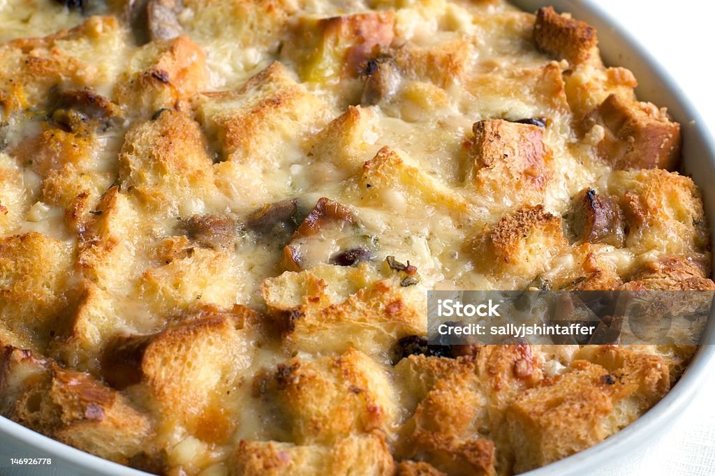 Savory Bread Pudding Closeup of golden melted cheese and savory bread pudding. Bread Dessert Stock Photo