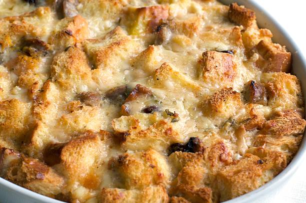 Savory Bread Pudding Closeup of golden melted cheese and savory bread pudding. savory food stock pictures, royalty-free photos & images