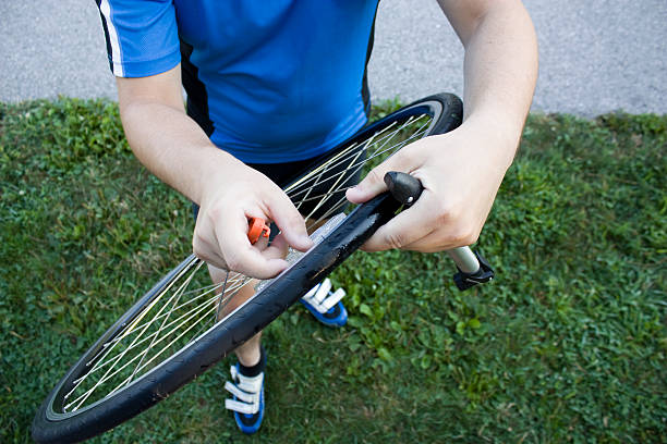 A cyclist changing his bike tire.