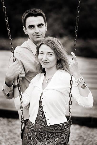 Young couple at kid's playground stock photo