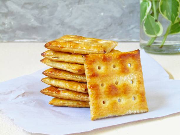 istock Crackers on a baking paper on a beige and gray background 1469277782