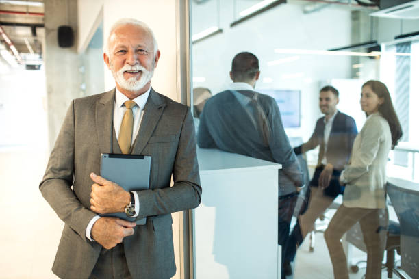 istock Confident senior man businessman working inside modern office on a digital tablet 1469278762