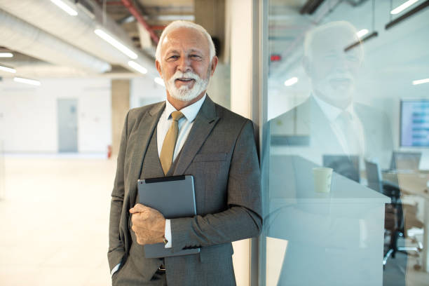 istock Confident senior man businessman working inside modern office on a digital tablet 1469278764