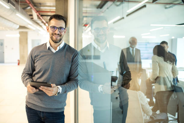 istock Confident young man businessman working inside modern office on a digital tablet 1469280327