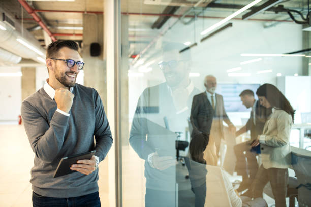 istock Confident young man businessman working inside modern office on a digital tablet 1469280479