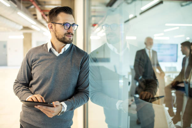 istock Confident young man businessman working inside modern office on a digital tablet 1469280481