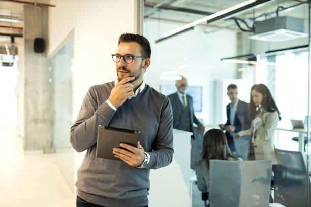 istock Confident young man businessman working inside modern office on a digital tablet 1469280702