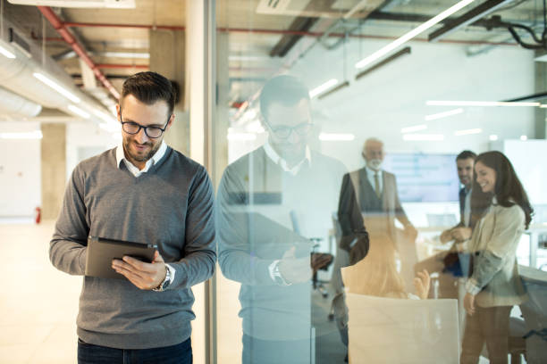 istock Confident young man businessman working inside modern office on a digital tablet 1469281021
