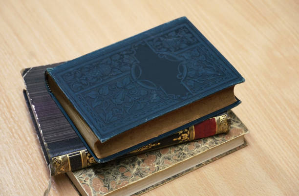 istock Beautiful vintage books with artistically decorated covers stacked on a table 1469283256