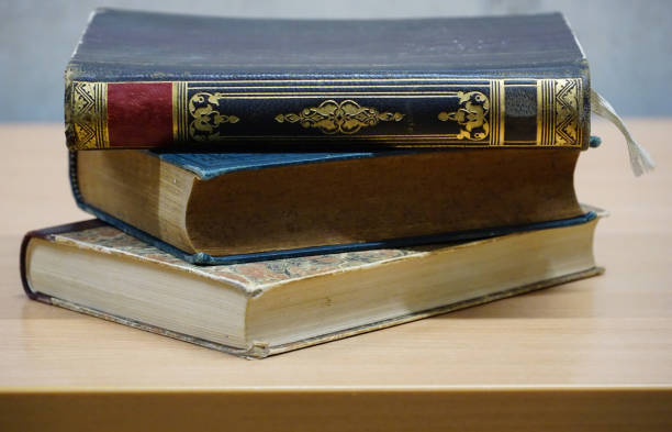 istock Three antique books with artistically decorated covers stacked on a table 1469283265