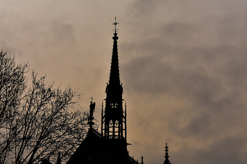 The tower of Sainte Chapelle during cloudy day, also during huge Saharan dust storm over Paris, that turned the sky orange.