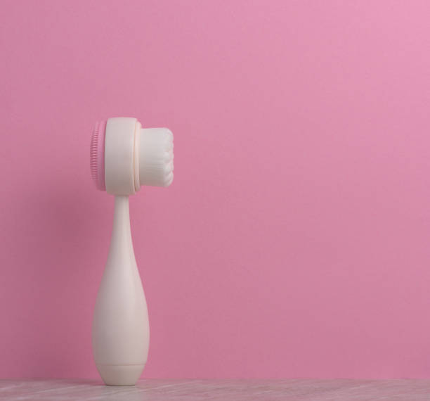 istock White plastic face scrub brush on a pink background, cosmetic tool 1469296448
