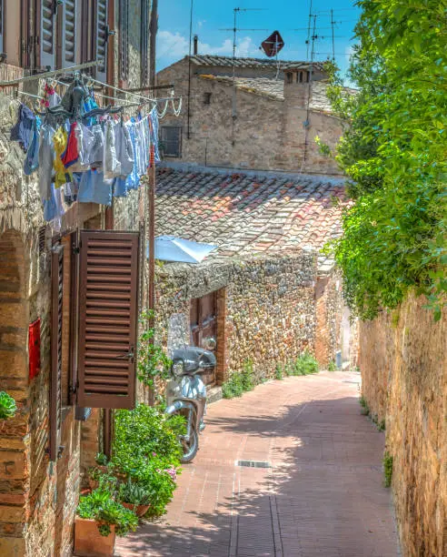 Photo of Narrow paved alley in world famous San Gimignano