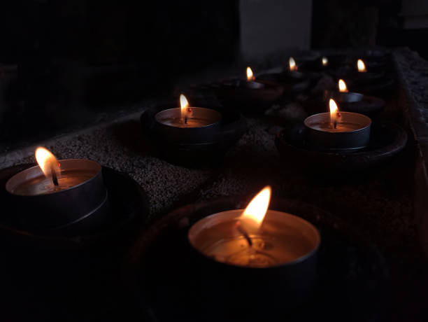 Candle lights in the night on dark background. Light of candles backgrounds. Candle lights in the night on dark background. Light of candles backgrounds. moment of silence stock pictures, royalty-free photos & images