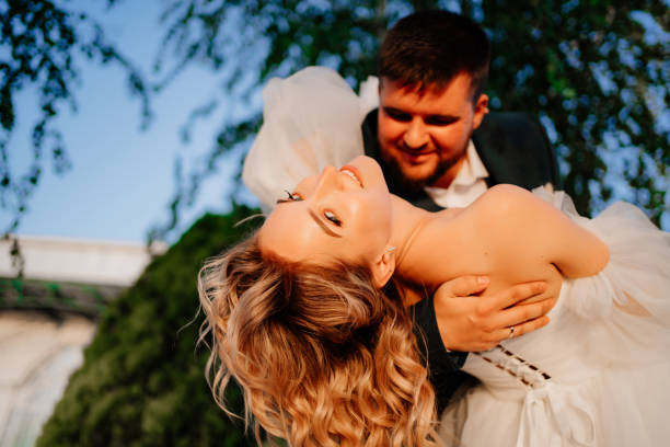 istock close up. dancing happy bride and groom in nature. 1469300094