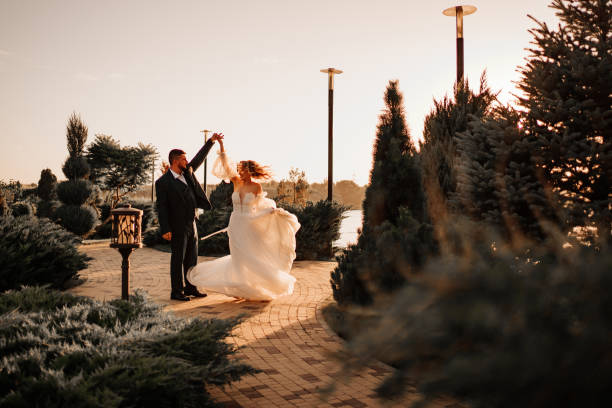 istock dancing happy bride and groom in nature. at sunset 1469302182