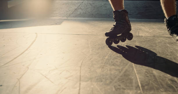 istock Young roller skater practicing stunt at skate park. Man legs in roller skates. 1469302551