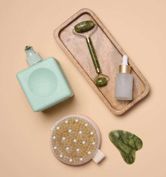 istock White bottle with dropper, a massage brush on a beige background, viewed from above. Cosmetic packaging 1469303393