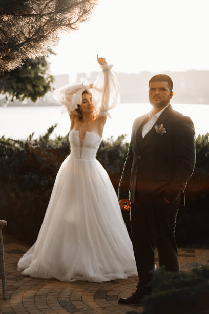 istock the bride and groom on the sunset by the river 1469303436