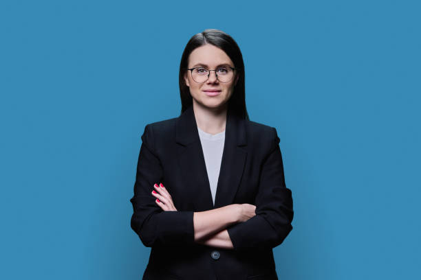 istock Confident business young female looking at camera on blue background 1469304256