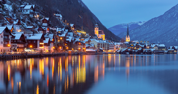 Picturesque view of the old city against the backdrop of mountains and a lake at sunset. Hallstatt. Austria.
