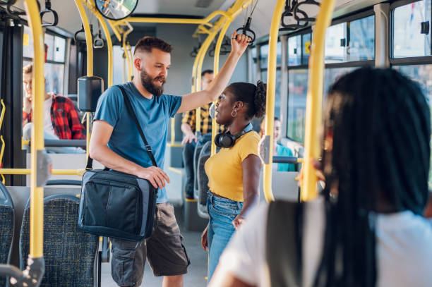 istock Multiracial friends talking and using a smartphone while riding a bus in the city 1469311012