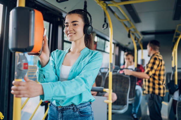 istock Woman riding in a bus and using a smartphone for paying a ticket 1469311021