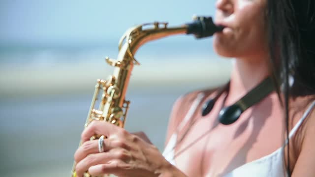 A beautiful girl performs on a golden saxophone in a beautiful cafe.