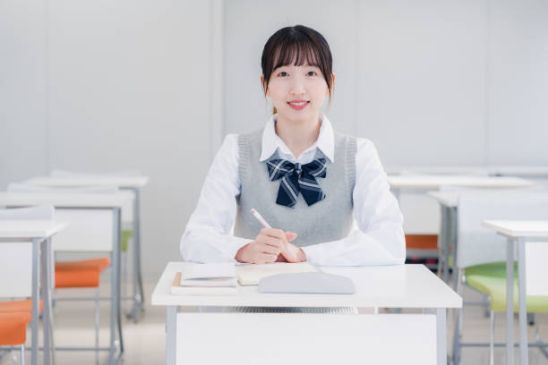 istock High school girls studying by themselves in a classroom 1469334132