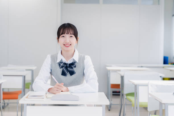 istock High school girls studying by themselves in a classroom 1469334137