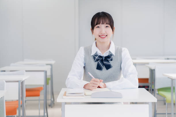 istock High school girls studying by themselves in a classroom 1469334151