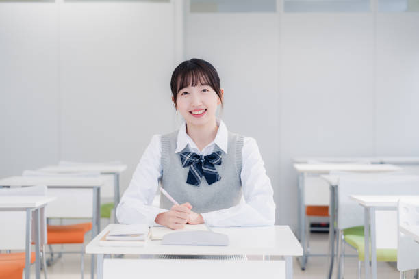 istock High school girls studying by themselves in a classroom 1469334160